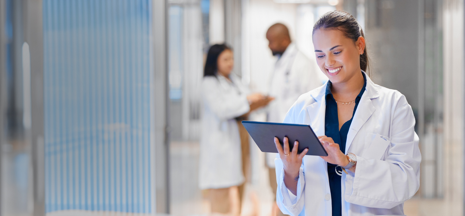 Woman in medical office reading a tablet